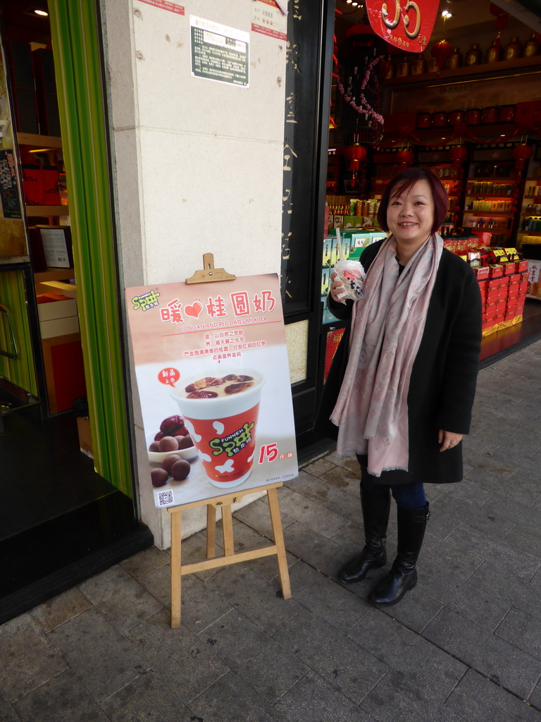 Miaomiao with a drink in front of the Funnew Spot bar at the Zhongshan Road Pedestrian Street