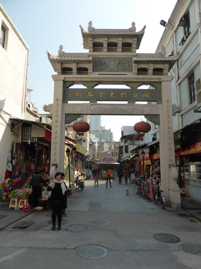 Miaomiao in front of the west gate to the Mintai Characteristic Food Street