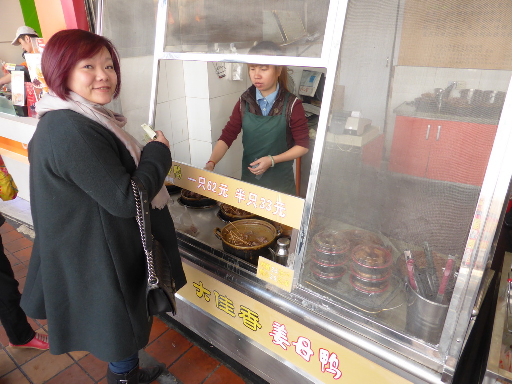 Miaomiao in front of a snackbar at Siming South Road