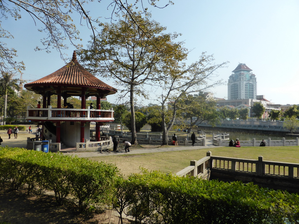 Pavilion and pool in the park in front of Nanputuo Temple and the tower of Xiamen University