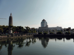 Eastern pagoda and the pool in the park in front of Nanputuo Temple and the tower of Xiamen University