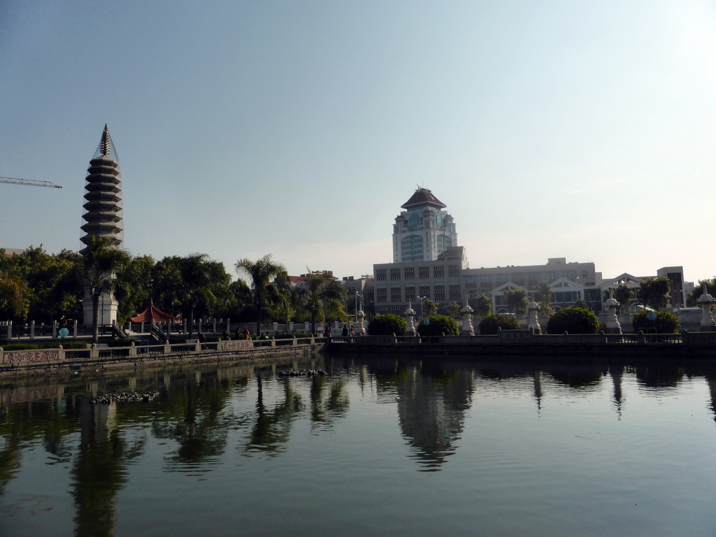 Eastern pagoda and the pool in the park in front of Nanputuo Temple and the tower of Xiamen University