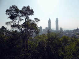 Trees and two skyscrapers under construction, viewed from the Tushita Building of the Nanputuo Temple