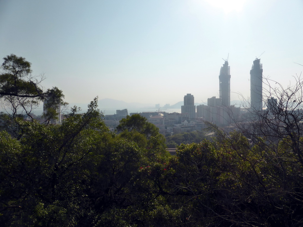 Trees and two skyscrapers under construction, viewed from the Tushita Building of the Nanputuo Temple