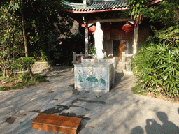 Statue, altar and monk in front of the Puzhao Temple at the back side of the Nanputuo Temple