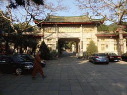 Monk in front of the entrance to the Monk Students Dormitory of the Nanputuo Temple