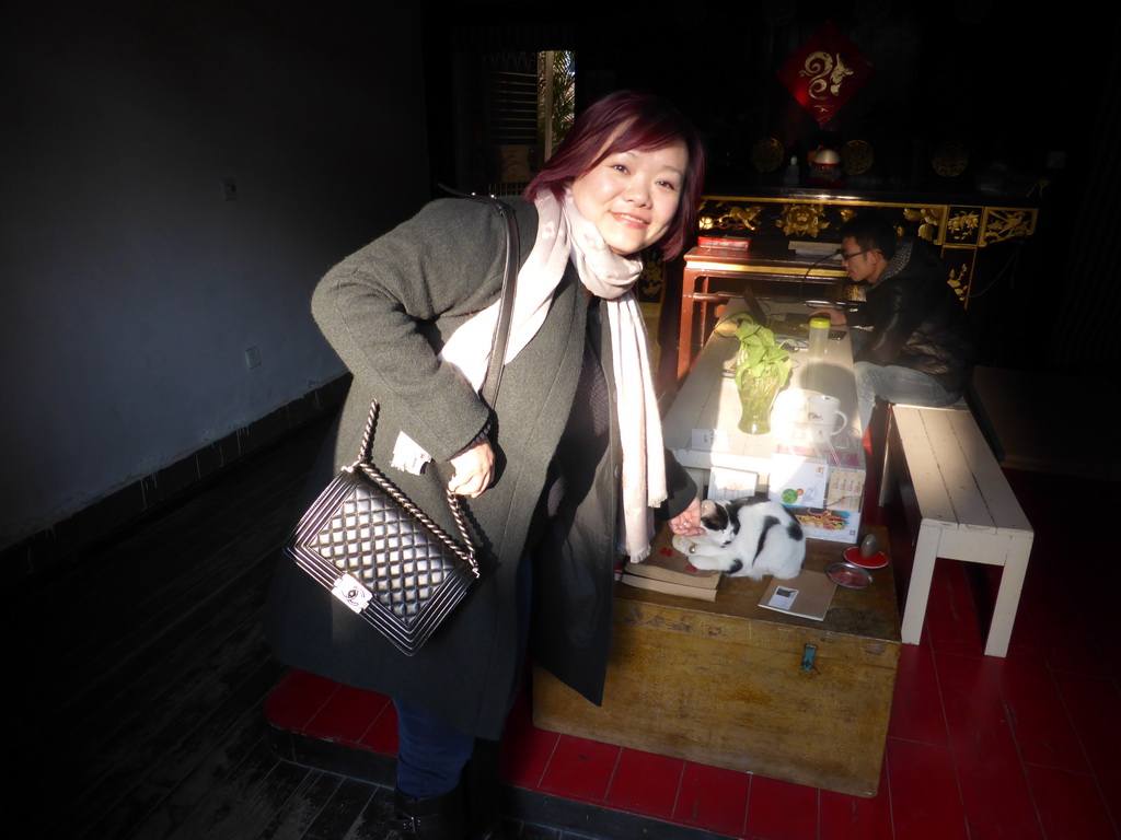 Miaomiao with a cat in a building at Zeng Cuo An Village