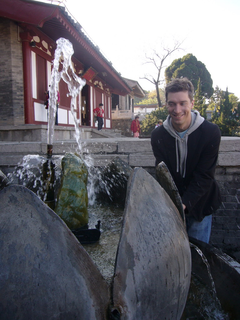 Tim with a fountain at the Huaqing Hot Springs