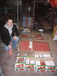 Tim with fruit at a market in the city center