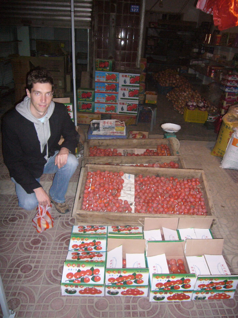 Tim with fruit at a market in the city center