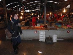 Miaomiao with seafood at an open market in the city center