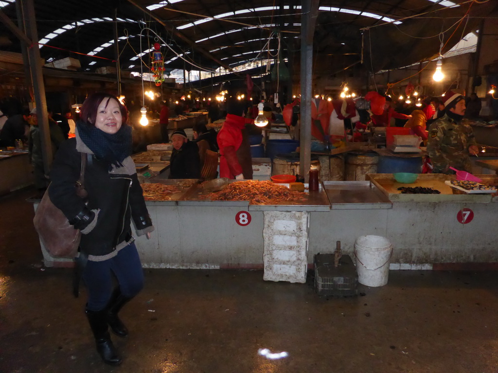 Miaomiao with seafood at an open market in the city center