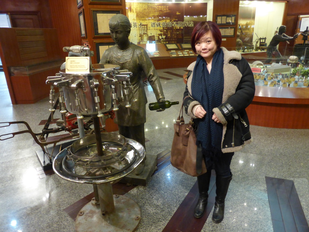 Miaomiao with a bottling machine at the ChangYu Wine Culture Museum