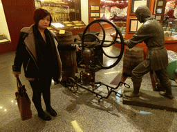 Miaomiao with a hand pump at the ChangYu Wine Culture Museum