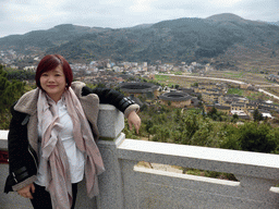 Miaomiao at the Yongding Scenic Area viewing point, with a view on the Qiaofu Lou, Chengqi Lou, Shize Lou and Beichen Lou buildings of the Gaobei Tulou Cluster