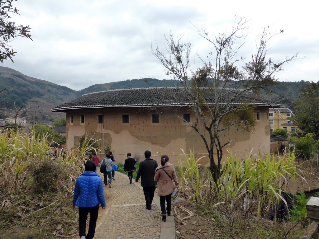 Miaomiao with the Qiaofu Lou building of the Gaobei Tulou Cluster