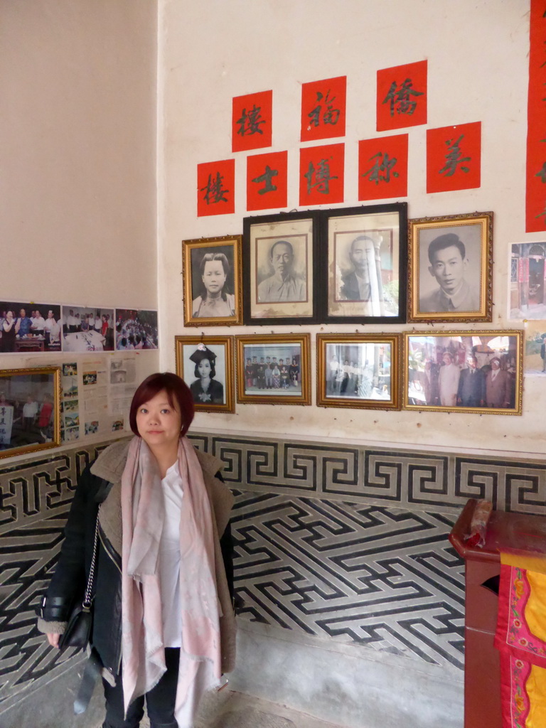 Miaomiao with photos of the founders of the Qiaofu Lou building of the Gaobei Tulou Cluster