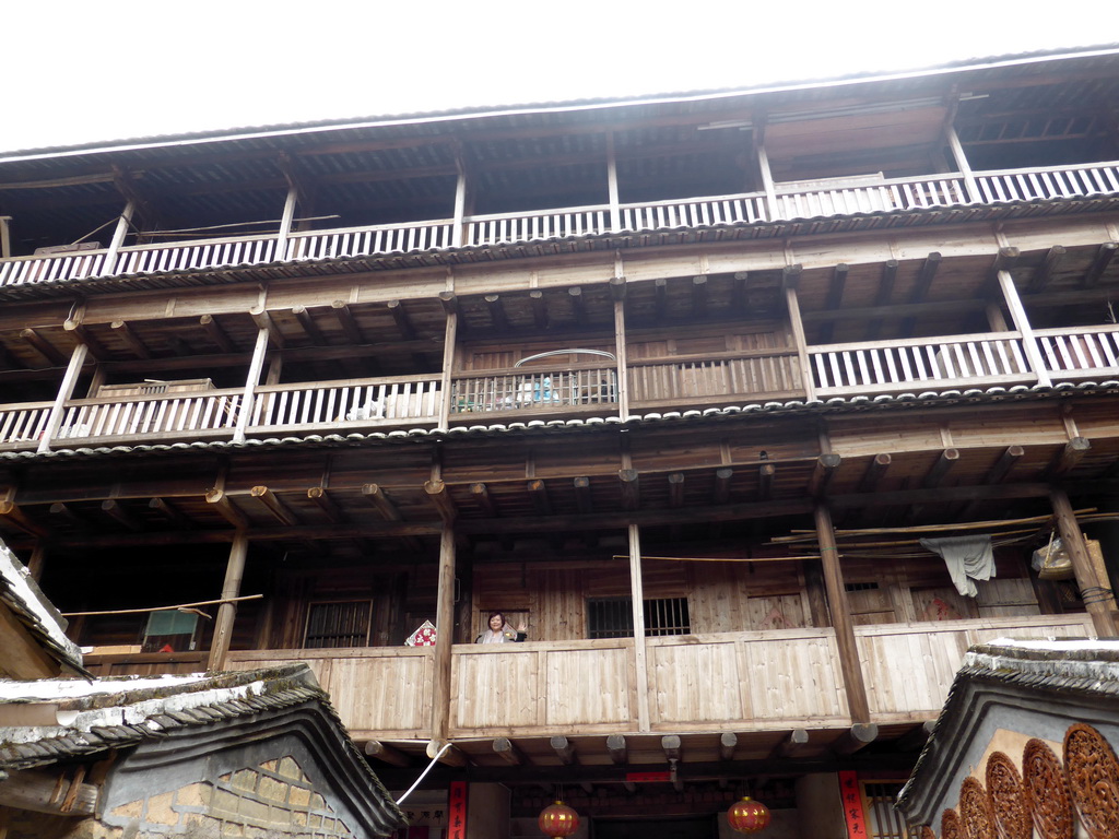 Miaomiao at the second level of the Shize Lou building of the Gaobei Tulou Cluster, viewed from the ground level