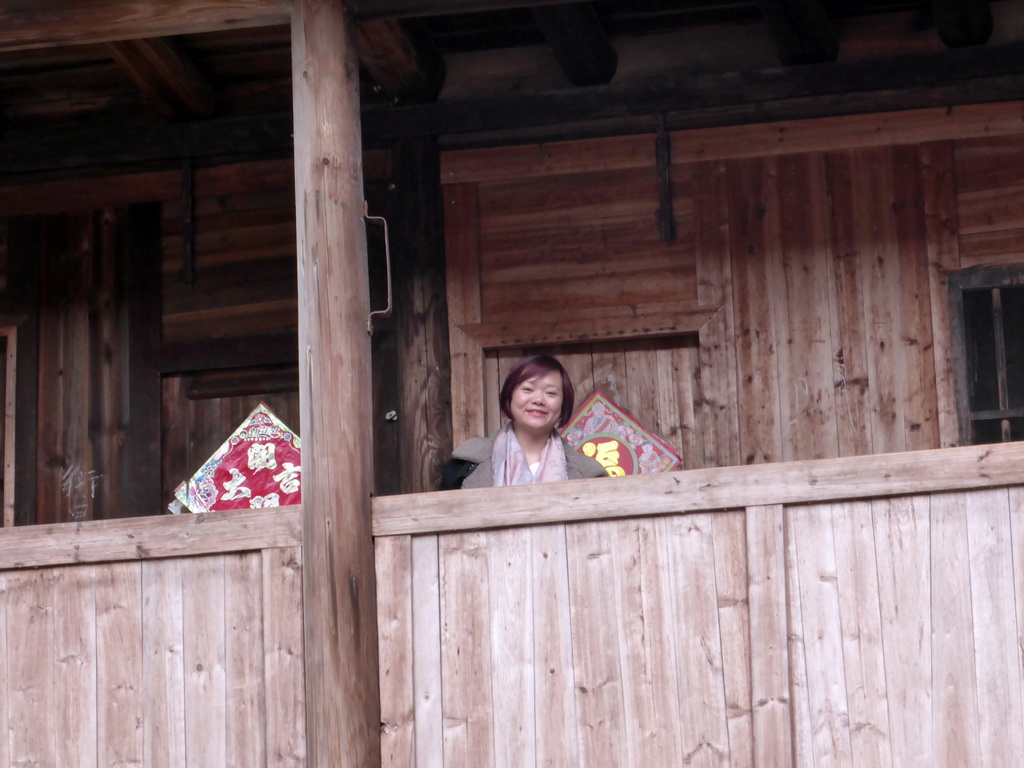 Miaomiao at the second level of the Shize Lou building of the Gaobei Tulou Cluster, viewed from the ground level