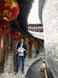 Tim with our photograph at the second inner layer on the ground level of the Chengqi Lou building of the Gaobei Tulou Cluster