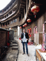 Tim with our photograph at the outer layer with all four levels of the Chengqi Lou building of the Gaobei Tulou Cluster