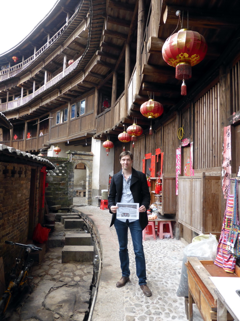 Tim with our photograph at the outer layer with all four levels of the Chengqi Lou building of the Gaobei Tulou Cluster