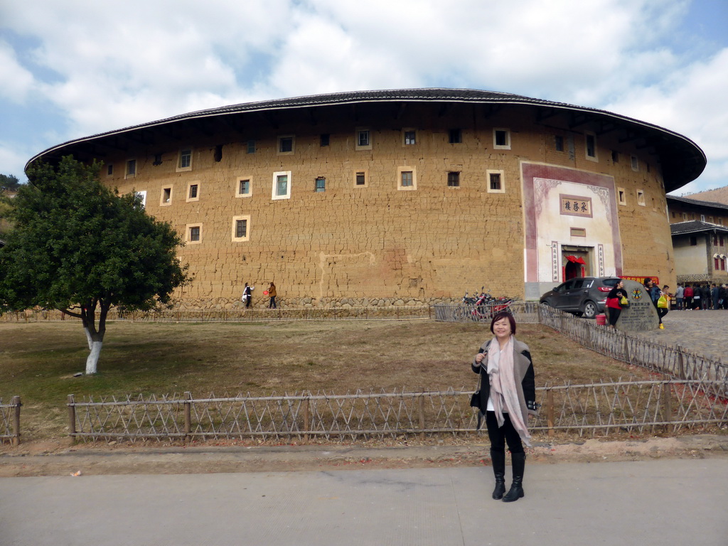 Miaomiao in front of the Chengqi Lou building of the Gaobei Tulou Cluster