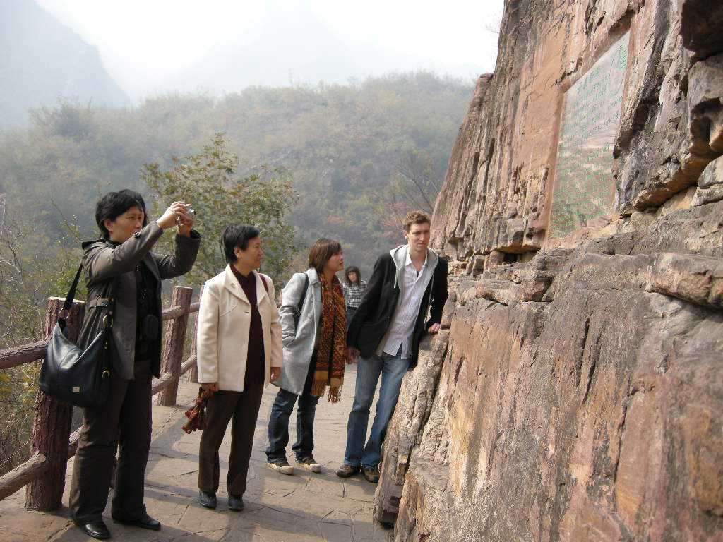 Tim, Miaomiao and Miaomiao`s mother at the red cliff and severed wall at the Red Stone Gorge at the Mount Yuntaishan Global Geopark