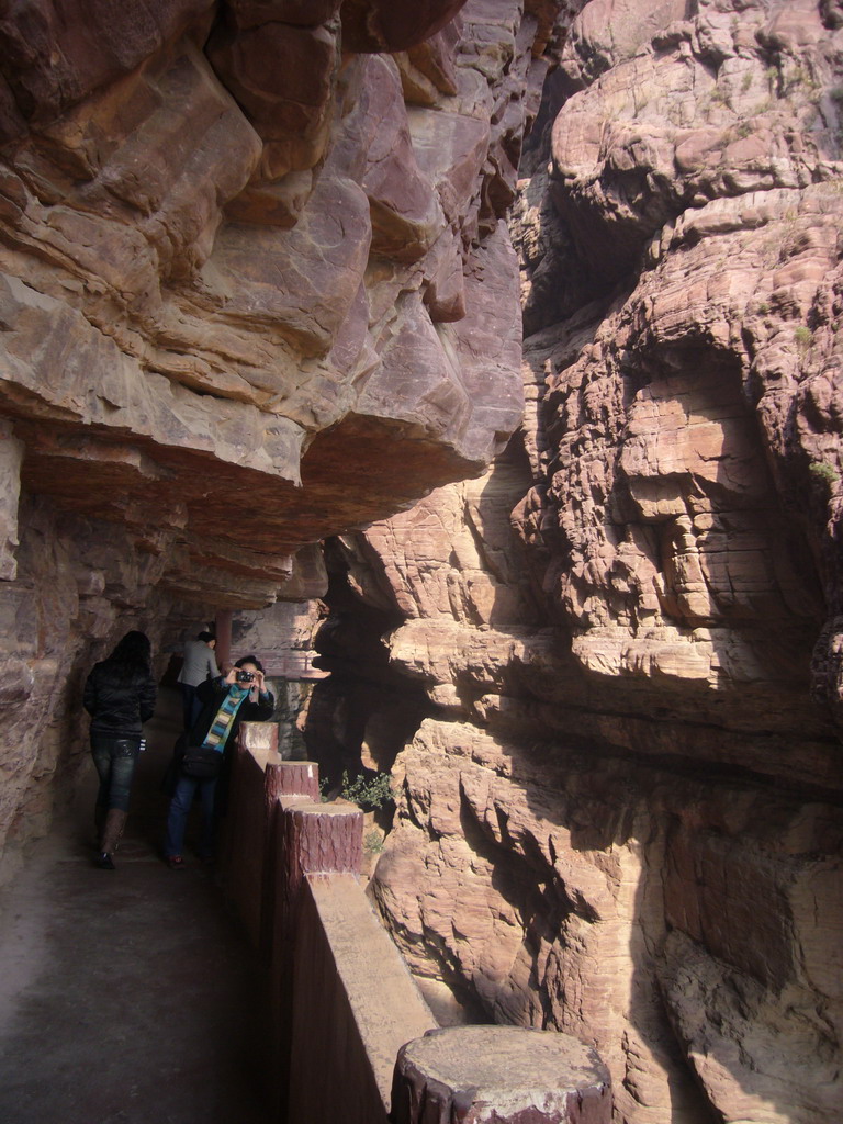 Miaomiao`s aunt at the mountainside path at the Red Stone Gorge at the Mount Yuntaishan Global Geopark