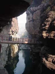 River and bridge at the Red Stone Gorge at the Mount Yuntaishan Global Geopark, viewed from the mountainside path