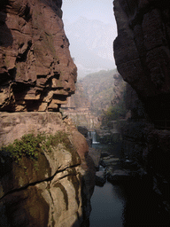River and bridge over the waterfall at the Red Stone Gorge at the Mount Yuntaishan Global Geopark, viewed from the bridge