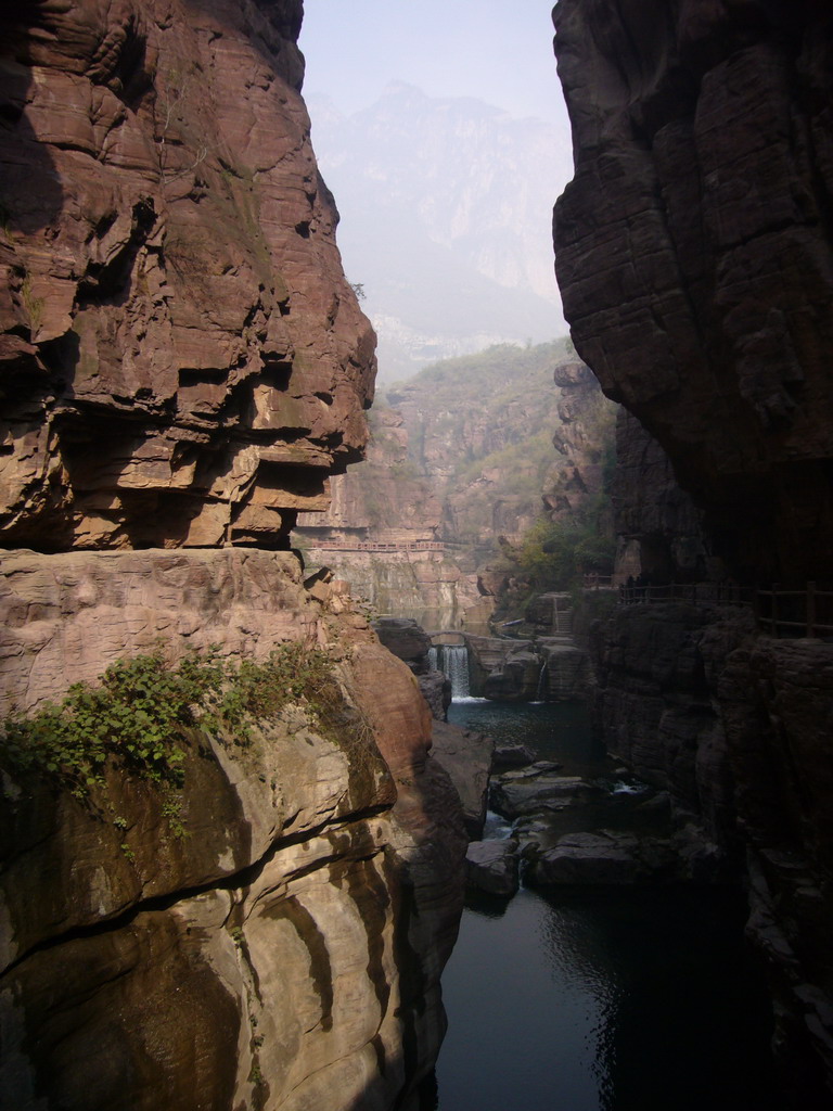 River and bridge over the waterfall at the Red Stone Gorge at the Mount Yuntaishan Global Geopark, viewed from the bridge