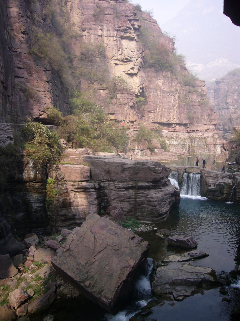 River and bridge over the waterfall at the Red Stone Gorge at the Mount Yuntaishan Global Geopark, viewed from the bridge