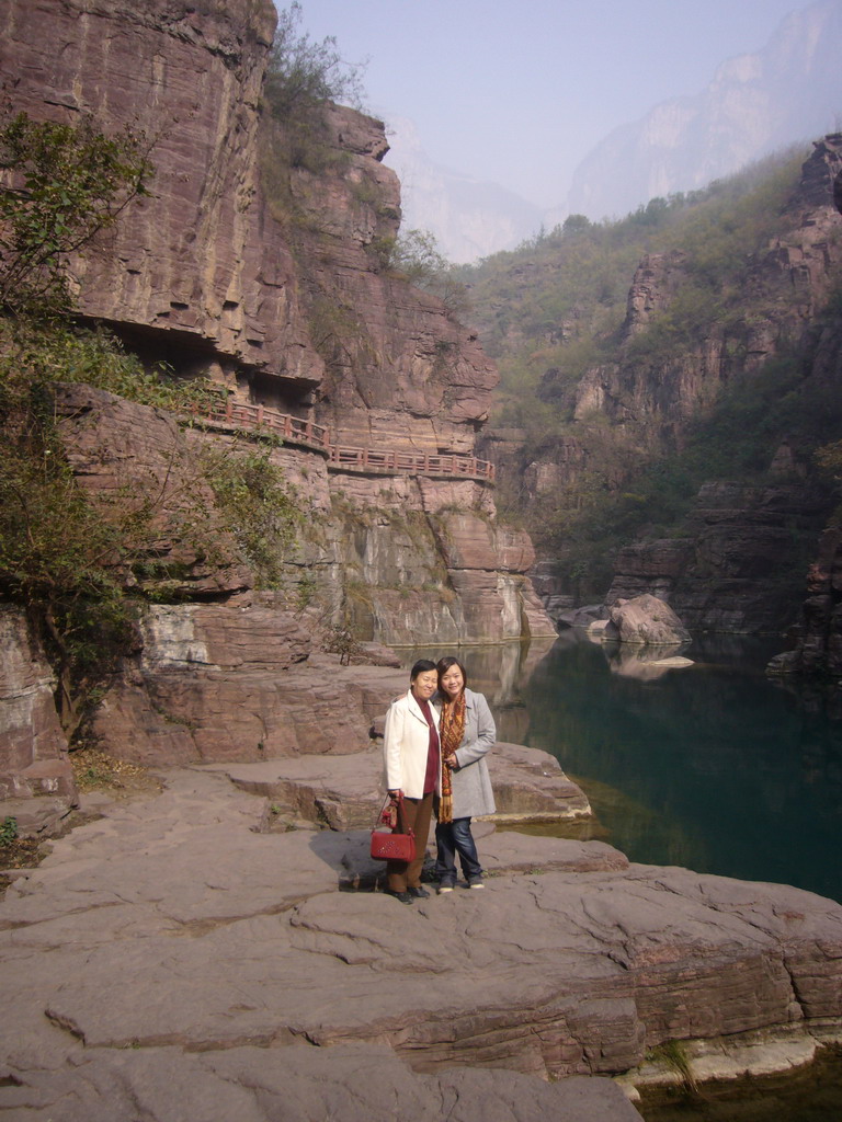 Miaomiao`s mother in front of the river at the Red Stone Gorge at the Mount Yuntaishan Global Geopark