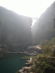 River, bridge over the waterfall and another bridge at the Red Stone Gorge at the Mount Yuntaishan Global Geopark, viewed from the mountainside path