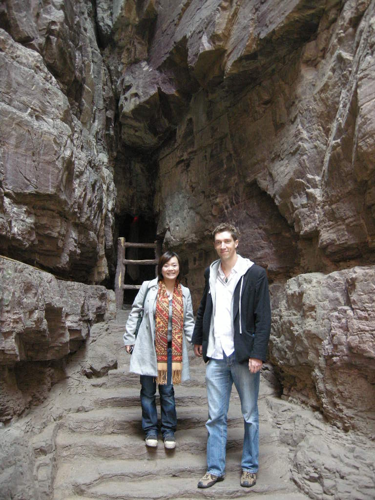 Tim and Miaomiao at a staircase at the mountainside path at the Red Stone Gorge at the Mount Yuntaishan Global Geopark