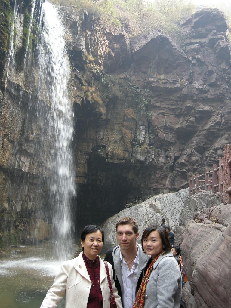 Tim, Miaomiao and Miaomiao`s mother at the waterfall at the Red Stone Gorge at the Mount Yuntaishan Global Geopark