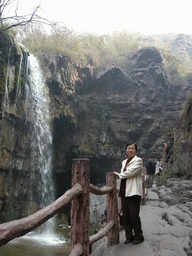 Miaomiao`s mother at the waterfall at the Red Stone Gorge at the Mount Yuntaishan Global Geopark