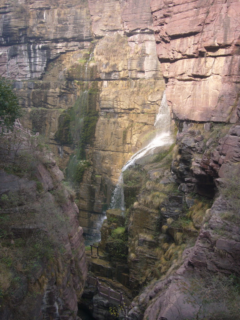 Waterfall at the Red Stone Gorge at the Mount Yuntaishan Global Geopark, viewed from the mountainside path