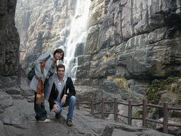 Tim and Miaomiao at the mountainside path at the Red Stone Gorge at the Mount Yuntaishan Global Geopark, with a view on the waterfall