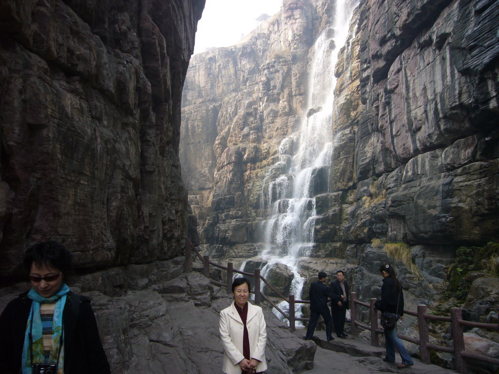 Miaomiao`s mother and aunt at the mountainside path at the Red Stone Gorge at the Mount Yuntaishan Global Geopark, with a view on the waterfall