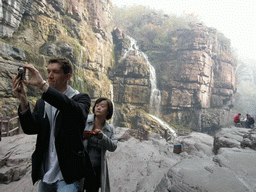 Tim and Miaomiao with waterfalls at the Red Stone Gorge at the Mount Yuntaishan Global Geopark