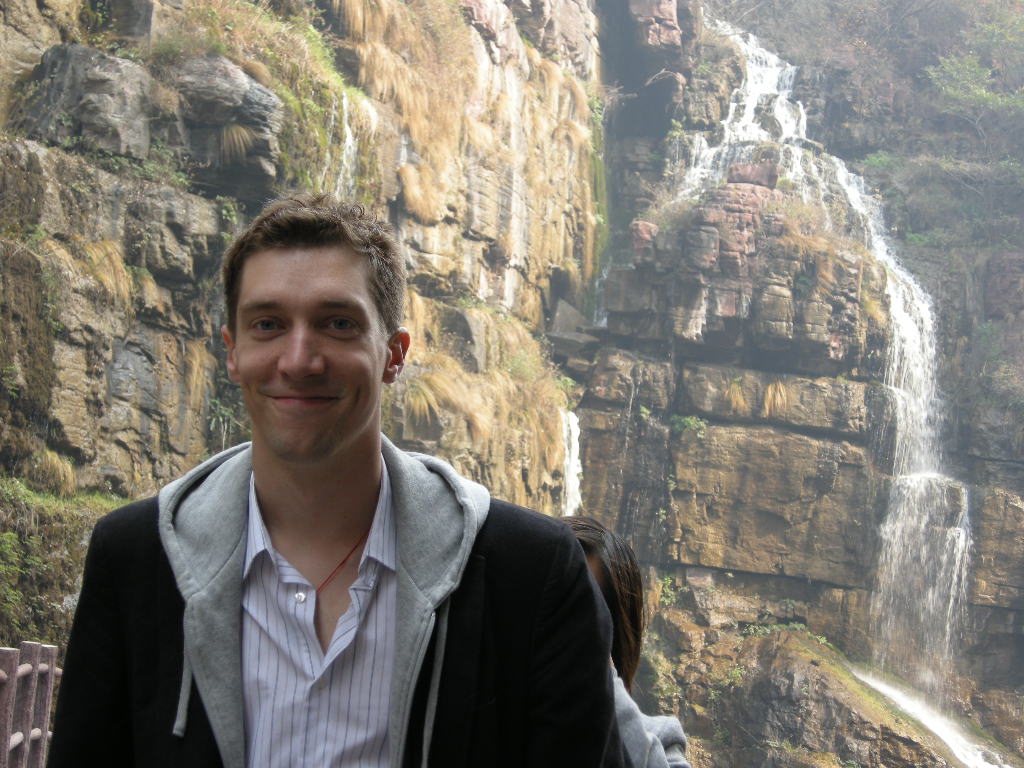 Tim and Miaomiao with waterfalls at the Red Stone Gorge at the Mount Yuntaishan Global Geopark