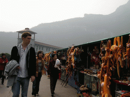 Tim, Miaomiao and Miaomiao`s mother with souvenir shops at the dam at the Ma`anshi Reservoir