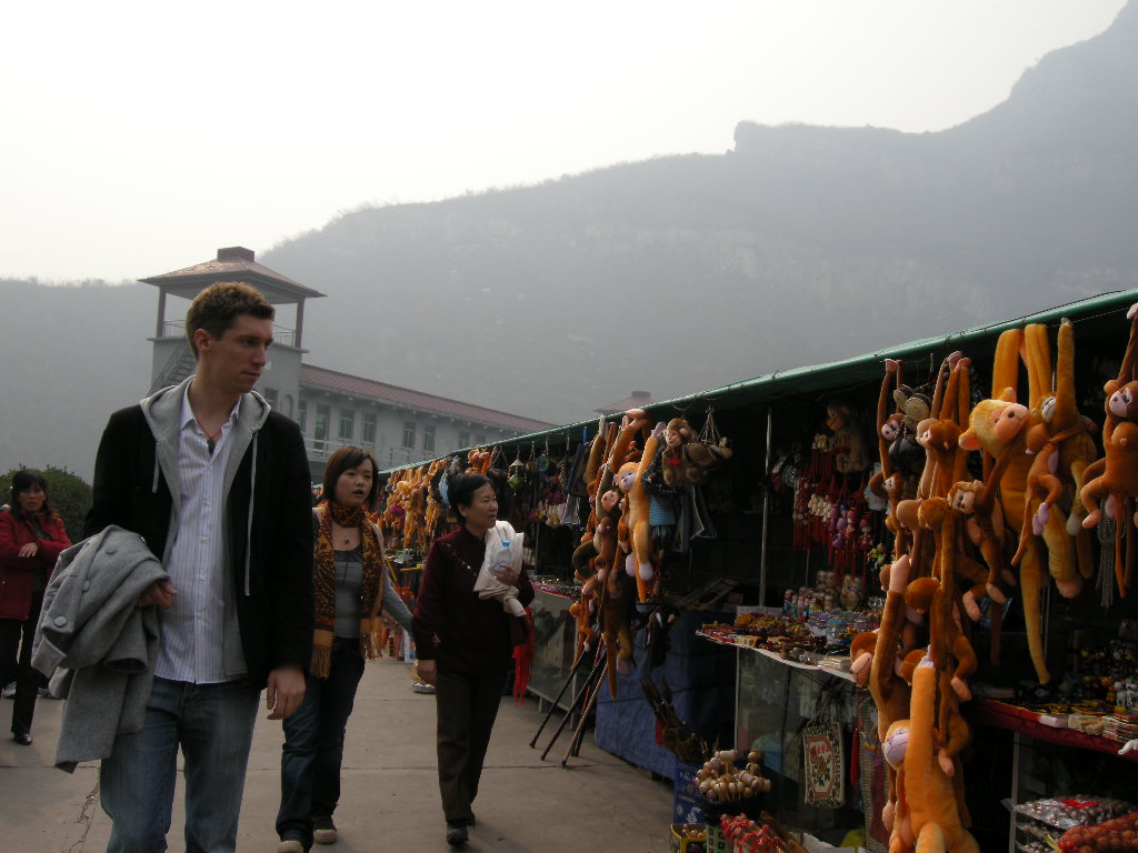 Tim, Miaomiao and Miaomiao`s mother with souvenir shops at the dam at the Ma`anshi Reservoir