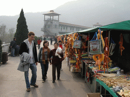 Tim, Miaomiao and Miaomiao`s mother with souvenir shops at the dam at the Ma`anshi Reservoir