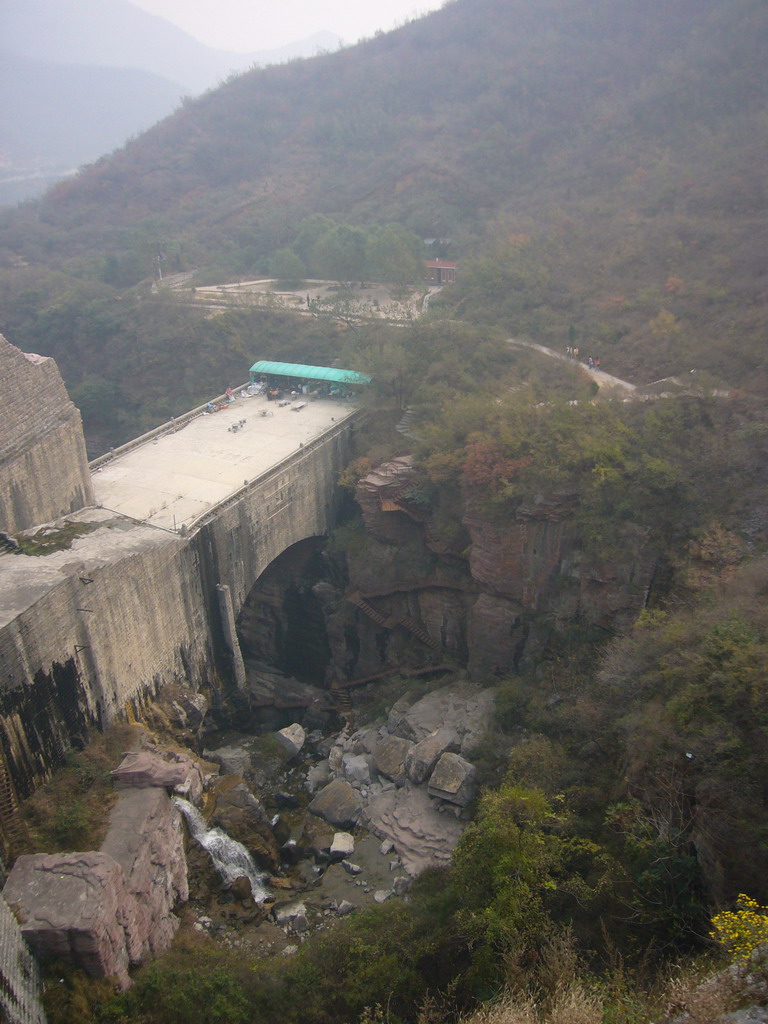 Waterfall an path at the Red Stone Gorge at the Mount Yuntaishan Global Geopark, viewed from the dam at the Ma`anshi Reservoir