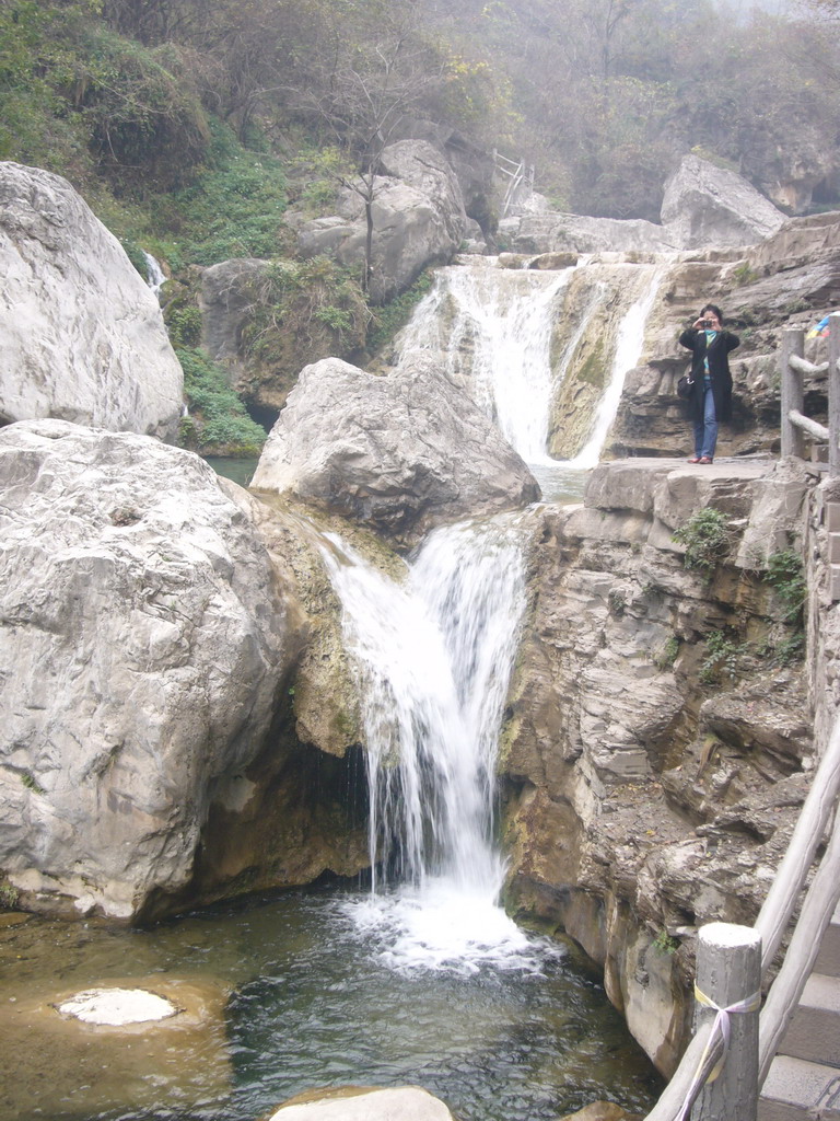 Miaomiao`s aunt at a waterfall at the Tanpu Gorge at the Mount Yuntaishan Global Geopark