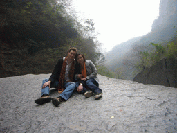 Tim and Miaomiao sitting on a rock at the Longfeng Gorge at the Mount Yuntaishan Global Geopark