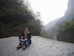 Tim sitting on a rock at the Longfeng Gorge at the Mount Yuntaishan Global Geopark